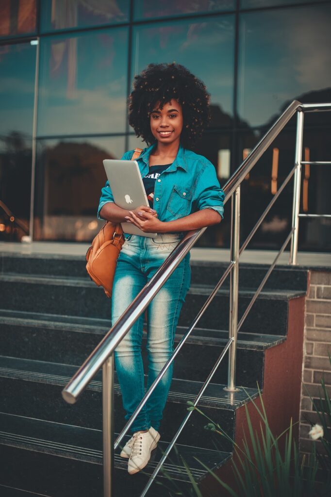 girl, student, campus, university, afro, laptop, macbook, stairs, steps, stand, standing, smile, smiling, smiling woman, young woman, happy, brazil, campus, campus, university, university, university, university, university